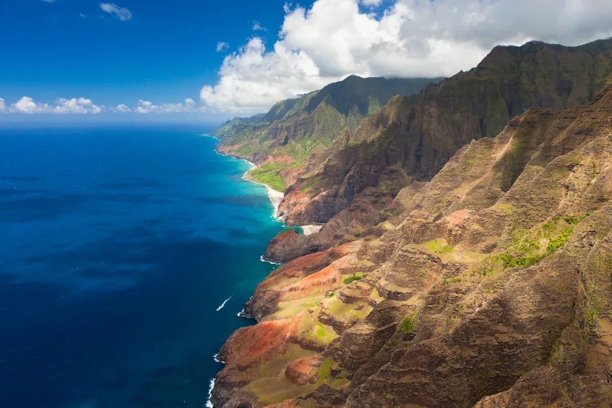 Aerial view of the Na Pali Coast ridges meeting the ocean, Kauai, for Napali Coast boat tours
